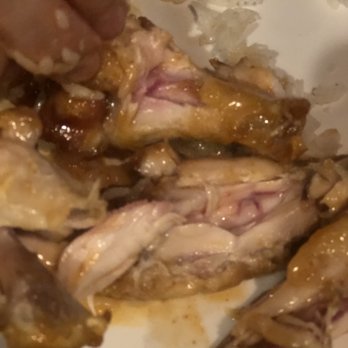 Buffalo Wild Wings - a person's hand grabbing a piece of meat - American Near Me - Cross Lanes, West Virginia