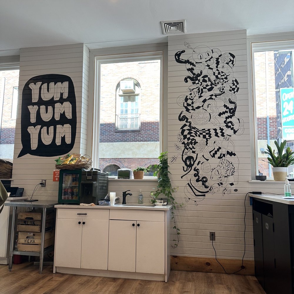 Huda - a kitchen with a large mural on the wall - Sandwiches Near Me - Philadelphia, Pennsylvania