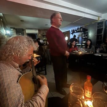 Restaurante Esquina de Alfama - My table is immediately to the right of the guitarist.  The man standing is one of the 4 singers who sang throughout the night. - Fado Houses Near Me - Lisbon, 11