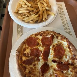 Fresh and hot pizza with hot side of fries Fresh and hot pizza with hot side of fries
