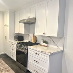 a clean kitchen with white cabinets a clean kitchen with white cabinets