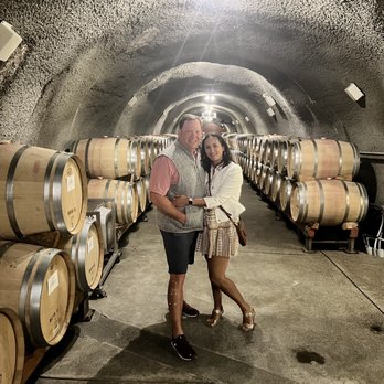 Pine Ridge Vineyards - a couple standing in a wine cellar - Wineries Near Me - Napa, California Pine Ridge Vineyards - a couple standing in a wine cellar - Wineries Near Me - Napa, California