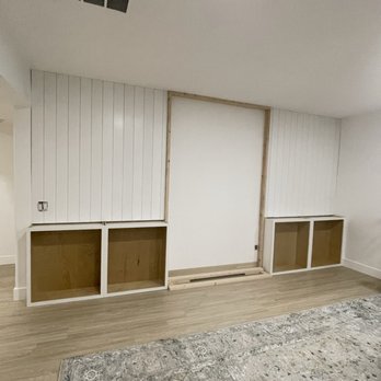 TNO Remodeling & Design - a living room with white walls and wood floors - General Contractors Near Me TNO Remodeling & Design - a living room with white walls and wood floors - General Contractors Near Me