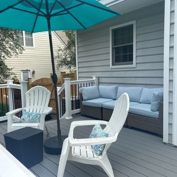 Contractors Next Project - a patio with two chairs and an umbrella - General Contractors Near Me