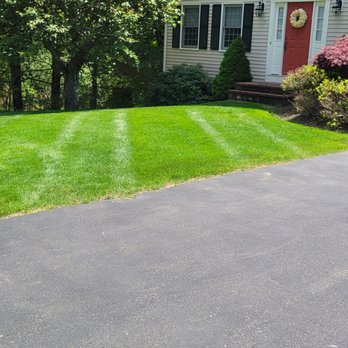 Alex Landscaping - the driveway of a home with a freshly mowed lawn - Landscaping Near Me - Norwood, Massachusetts