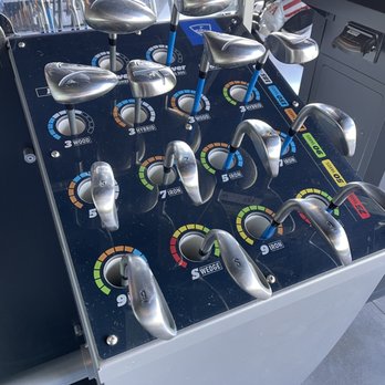 Topgolf - Variety of clubs available - A golf club selection panel displays multiple clubs with adjustable settings for different types and distances. - New American Near Me - Albuquerque, New Mexico