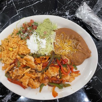 Tacos El Cunado - Chicken fajitas with corn shells, rice, beans, and "salad". - Mexican Near Me - Cedar Springs, Michigan Tacos El Cunado - Chicken fajitas with corn shells, rice, beans, and "salad". - Mexican Near Me - Cedar Springs, Michigan