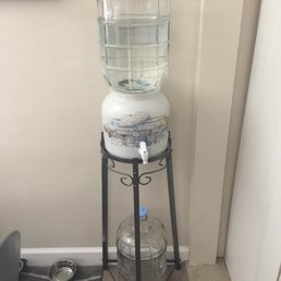 a water dispenser on a stand a water dispenser on a stand