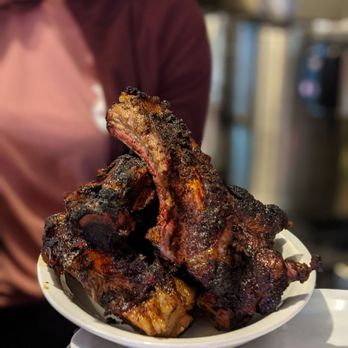 Rib Hut - a plate of ribs on a stack of plates - Barbeque Near Me - El Paso, Texas Rib Hut - a plate of ribs on a stack of plates - Barbeque Near Me - El Paso, Texas