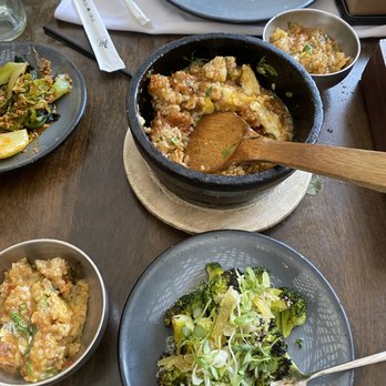 Kyu - Thai fried rice stone pot, with my grilled broccoli with ginger in the foreground - Asian Fusion Near Me - Miami, Florida Kyu - Thai fried rice stone pot, with my grilled broccoli with ginger in the foreground - Asian Fusion Near Me - Miami, Florida
