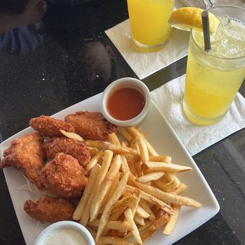 Table at Poipu - Chicken wings & fries -- Lilikoi Spiked Lemonade - New American Near Me - Koloa, Hawaii