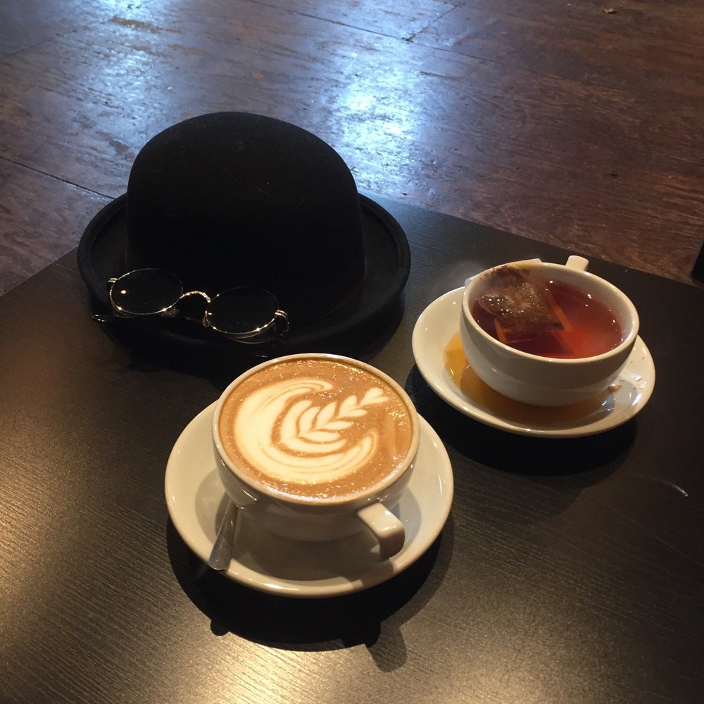 Corner Coffee Uptown - Just a Bourbon Carmel Latte, Missouri Gold Tea, and a Bowler hat. - Coffee & Tea Near Me - Minneapolis, Minnesota Corner Coffee Uptown - Just a Bourbon Carmel Latte, Missouri Gold Tea, and a Bowler hat. - Coffee & Tea Near Me - Minneapolis, Minnesota