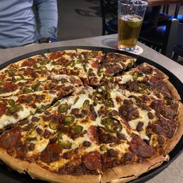 a pizza with pepperoni, jalapenos, and cheese a pizza with pepperoni, jalapenos, and cheese