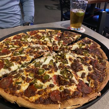 Texas Cafe & Bar - a pizza with pepperoni, jalapenos, and cheese - Barbeque Near Me - Lubbock, Texas Texas Cafe & Bar - a pizza with pepperoni, jalapenos, and cheese - Barbeque Near Me - Lubbock, Texas