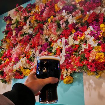 Electric Bicycle Brewing - a hand holding a pint of beer - Breweries Near Me - Vancouver, British Columbia