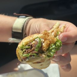 The carne sandwich, kale, cueso, fried onion & savory dressing