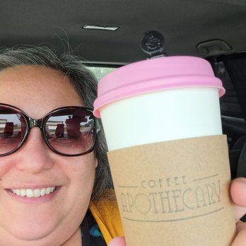 Coffee Apothecary - a woman holding a cup of coffee - Coffee & Tea Near Me - Bettendorf, Iowa