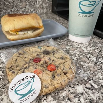 Gerry’s Cafe - The Arlington breakfast sandwich (sausage, egg, and cheese), M&M cookie, caramel latte - Coffee & Tea Near Me - Arlington Heights, Illinois