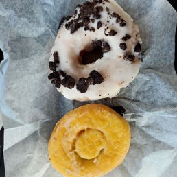 A cookies and cream and a blueberry filled donut A cookies and cream and a blueberry filled donut