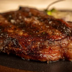 NANDO Wood-Fired Steak & Seafood - A beautifully prepared steak highlights the wood-fired cooking at NANDO Wood-Fired Steak & Seafood in Evansville, IN, where f...