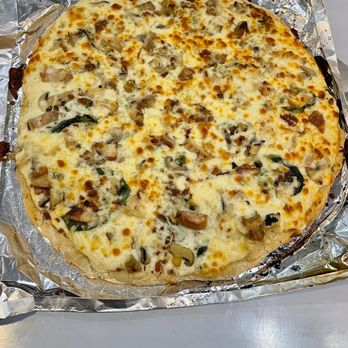 B, Pizza - a cheese and mushroom pizza on aluminum foil - Pizza Near Me - Conover, Ohio
