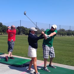 Jennifer Bermingham Golf Academy - Jennifer telling me to stop trying to murder the ball and my buddy crushing his drive behind me.