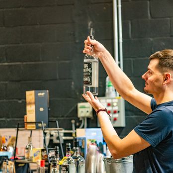 Big Machine Distillery - a man pouring a glass of alcohol - Distilleries Near Me - Lynnville, Tennessee