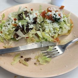 Carne asada scope with a bite taken and a chicken taco. Carne asada scope with a bite taken and a chicken taco.
