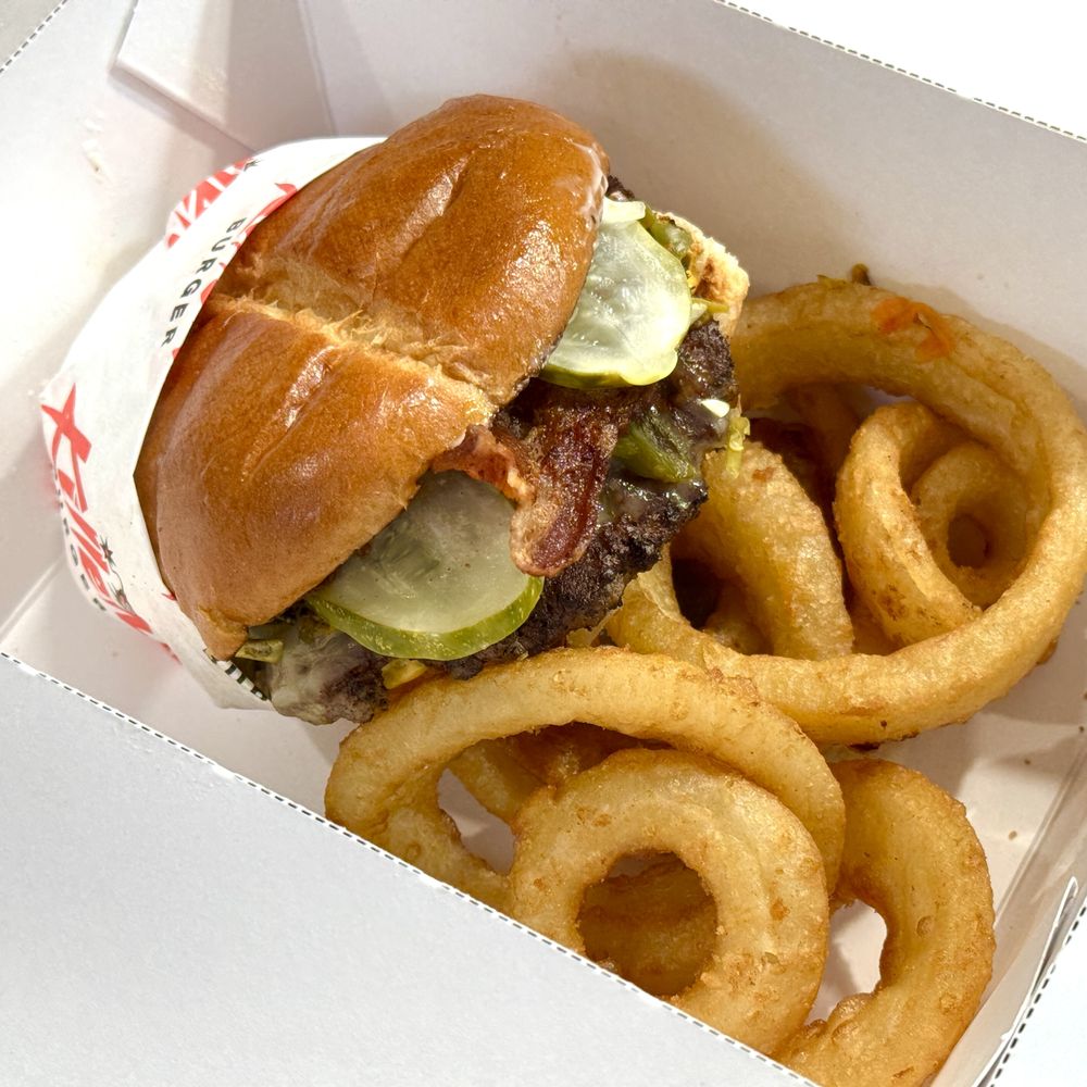 Jose Mendoza burger, limp onion rings in a to-go box. Jose Mendoza burger, limp onion rings in a to-go box.