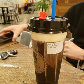 Mr. Mustache Tea & Dessert - a man using a laptop - Bubble Tea Near Me - Burnaby, British Columbia