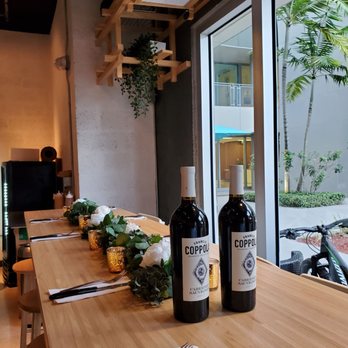 Cotto Pizza - two bottles of wine on a table - Pizza Near Me - Doral, Florida Cotto Pizza - two bottles of wine on a table - Pizza Near Me - Doral, Florida