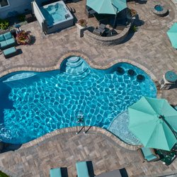 Wahoo Pools - Backyard Pool with sunshelve and barstools. Freedom, WI
