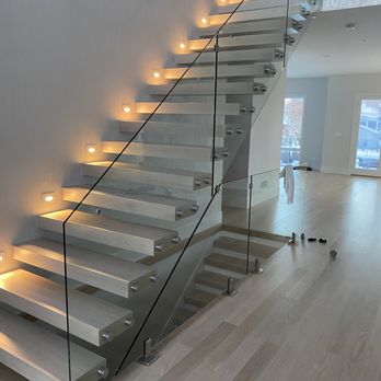 Source One Hardwood Flooring - a staircase with glass railings - Flooring Near Me Source One Hardwood Flooring - a staircase with glass railings - Flooring Near Me
