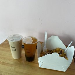 Large classic milk tea, large mango flavoured tea with tapioca & bubble waffle with chocolate sauce & icing sugar. Large classic milk tea, large mango flavoured tea with tapioca & bubble waffle with chocolate sauce & icing sugar.