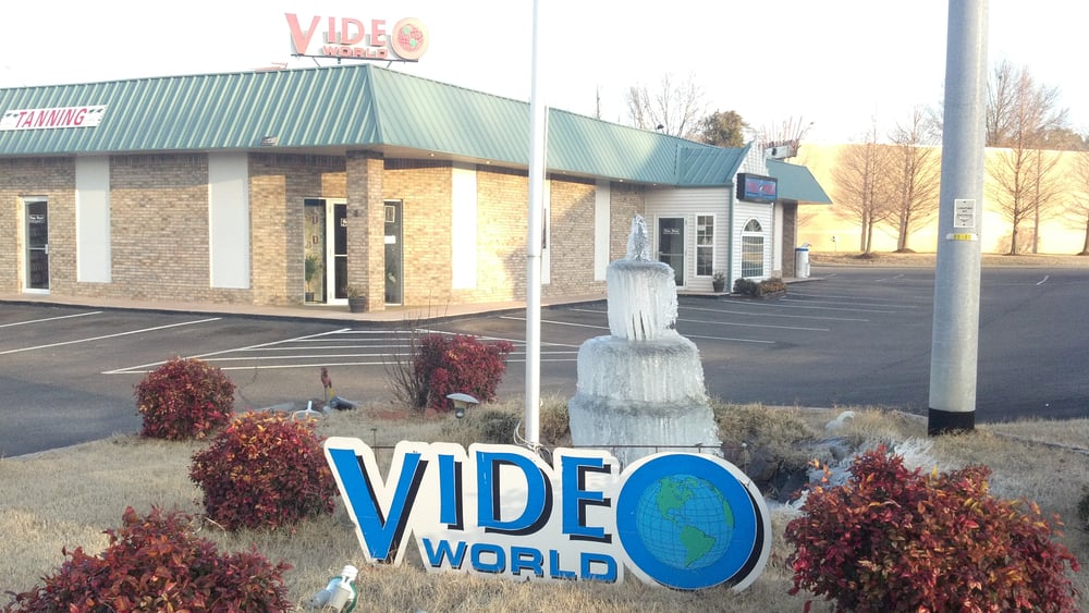 Video World & Tanning Salon Logo