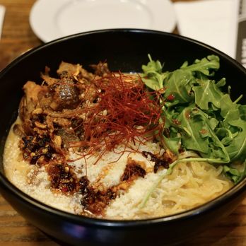 Kuu - a bowl of food on a wooden table - Ramen Near Me - New York, New York