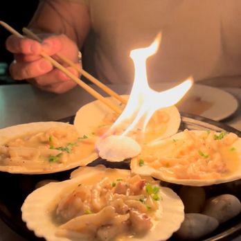 Paperfish Sushi - This dish was absolutely amazing. I believe it was squid and comes to the table with a flaming center piece - Sushi Bars Near Me - Miami, Florida