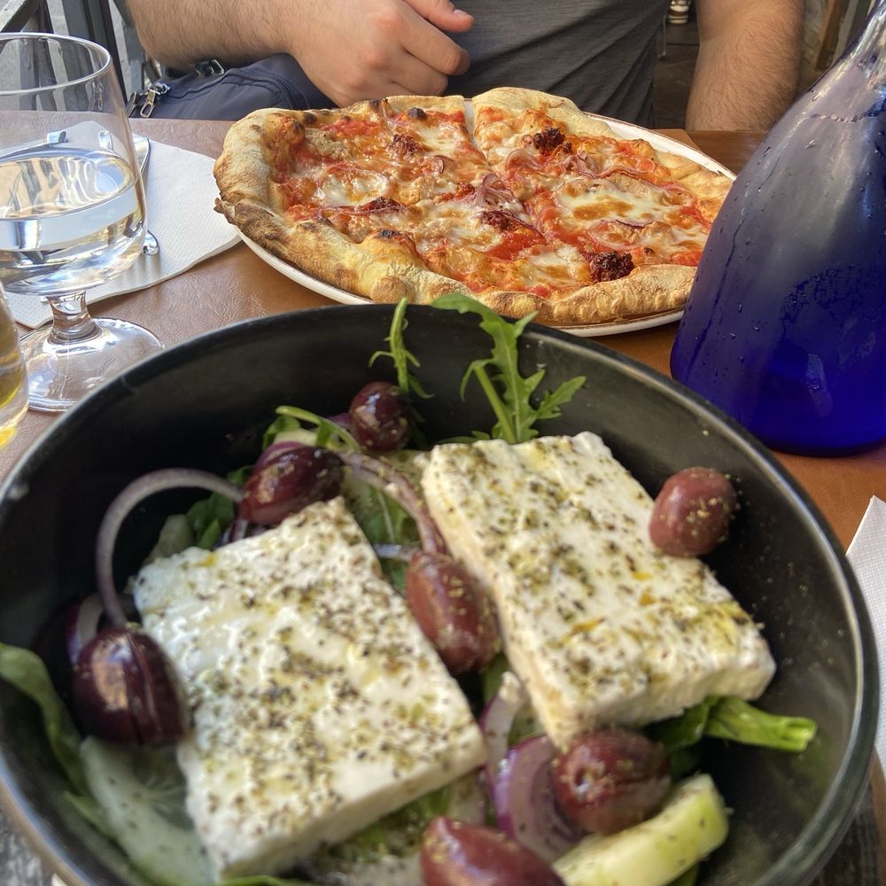 Greek salad and pizza Greek salad and pizza