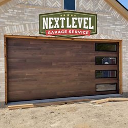 Next Level Garage Service - Custom wood overlay garage door with windows on the side