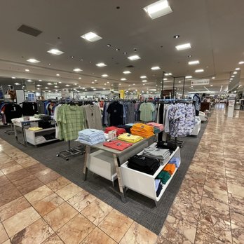 Macy's - Clothing racks and tables with various shirts and apparel are arranged inside Macy's in Albuquerque, NM. - Department Stores Near Me - Albuquerque, New Mexico