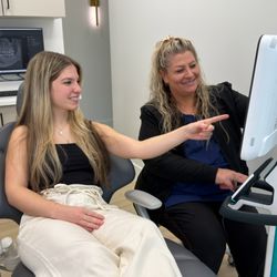 26 North Dental - Discussing Invisalign treatment options and reviewing potential smile outcomes with a patient during their initial consultation at 26 North
