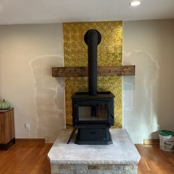 Custom Fireplace & Chimney Care - Free standing wood stove installed on Indiana Limestone hearth.