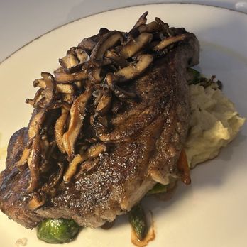 Toscana Italian Steakhouse - A ribeye steak on top of vegetables and mashed potatoes - Venues & Event Spaces Near Me - Amarillo, Texas
