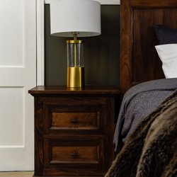 Inland Fine Furnishings - Warm wood tones on this custom bedroom furniture create a luxurious and cozy atmosphere. Perfect for a good night's rest.
