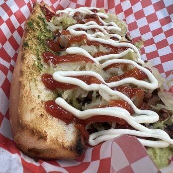 Shucos Los Meros Meros - a hot dog covered in ketchup - Food Trucks Near Me - Van Nuys, California Shucos Los Meros Meros - a hot dog covered in ketchup - Food Trucks Near Me - Van Nuys, California