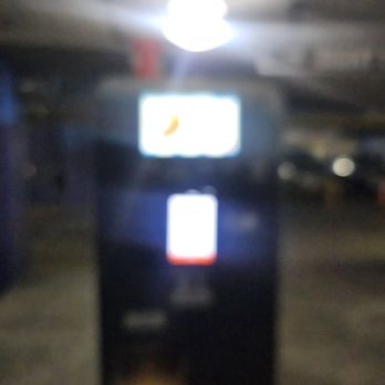 Target - Fee needing to be paid - A parking payment kiosk with two illuminated screens is shown in a dimly lit parking garage, with a bright ceiling light overhead. - Department Stores Near Me - Washington, DC, District of Columbia