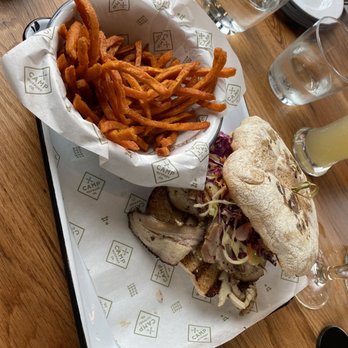 Camp Outpost - ROTISSERIE PORCHETTA SANDWICH & SWEET POTATO FRIES - New American Near Me - San Antonio, Texas