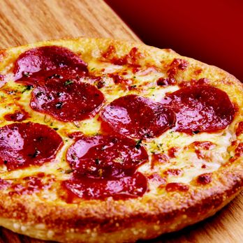 Husson's Pizza - a pepperoni pizza on a wooden board - Pizza Near Me - Saint Albans, West Virginia Husson's Pizza - a pepperoni pizza on a wooden board - Pizza Near Me - Saint Albans, West Virginia