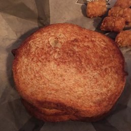 The sourdough egg and ham omelet sandwich and a few hash browns.