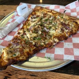 BBQ chicken pizza slice and AirPods Pro for size context. BBQ chicken pizza slice and AirPods Pro for size context.